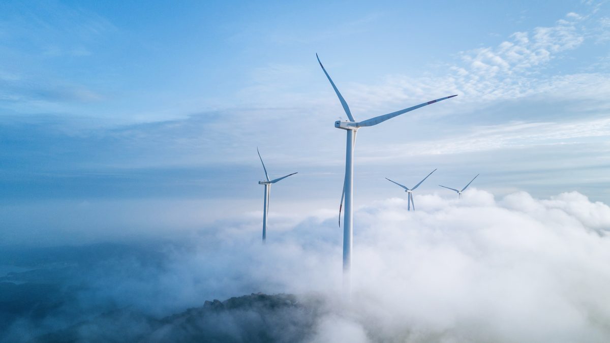Wind turbines rising above a sea of cloud